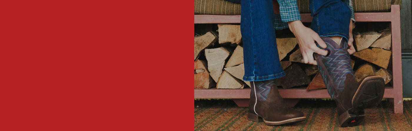 A woman sat down putting on a pair of Durango western boots.